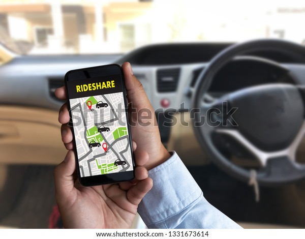 mobile application Ride share taxi service on phone\
man holding phone