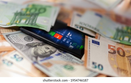 Mobile banking and finance concept: smartphone with stock exchange market application, euro and US dollar banknotes. Business background. Blurred concept