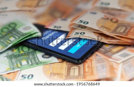 Mobile banking and finance concept: smartphone with stock exchange market application, euro banknotes. Business background. Blurred concept