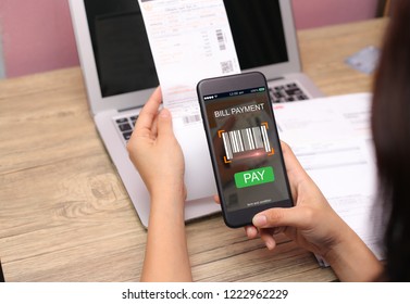 Mobile Bill Payment Barcode Scan Concept.Female Hands Using Mobile Phone And Holding Bills