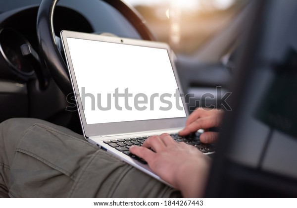 Mobile car service engineer checking\
car with his laptop on the road. Road assistance\
concept