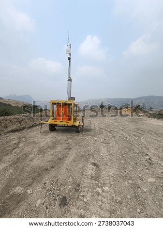 Mobile communication tower operating in a mining area, supporting wireless connectivity and network infrastructure for industrial operations. Concept of telecommunications, remote site connectivity, heavy industry, and modern mining technology