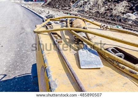Mobile compressor with a jackhammer parked at building site