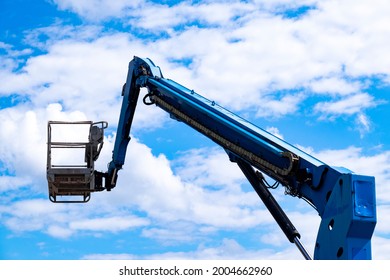 Mobile Crane Basket Against Clouded Blue Sky.