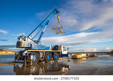 Mobile Crane Lifting Structure at Dockside. Heavy duty mobile crane parked near the sea