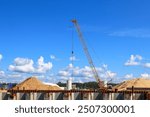 Mobile Crane on a road and tower crane in construction site.