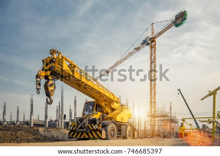 Mobile Crane on a road and tower crane in construction site