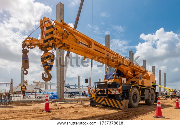 Mobile Crane on a road and tower crane in\
construction site