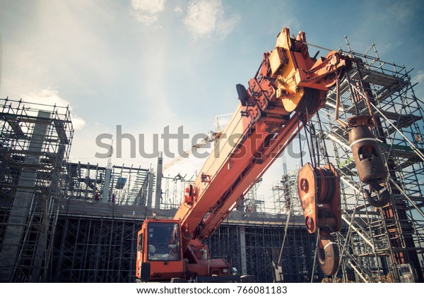 Mobile Crane on a road and tower crane in\
construction site