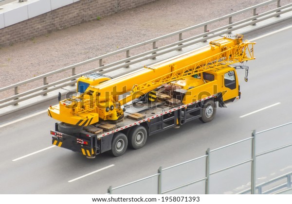 Mobile crane truck\
driving on the highway