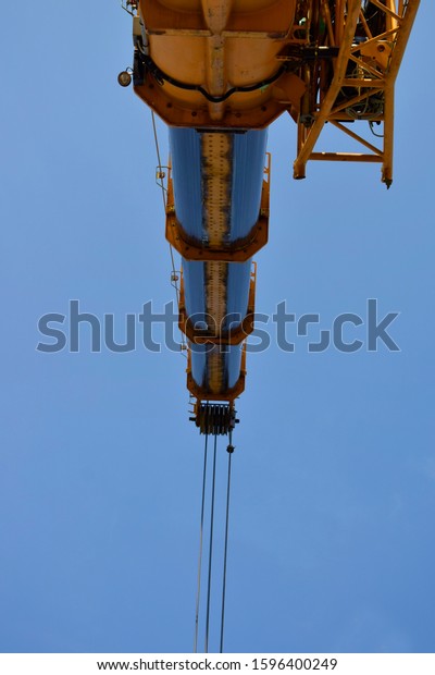 Mobile cranes working\
lifting equipment on construction site,Hydraulic cylinder,Boom\
crane. December 2019