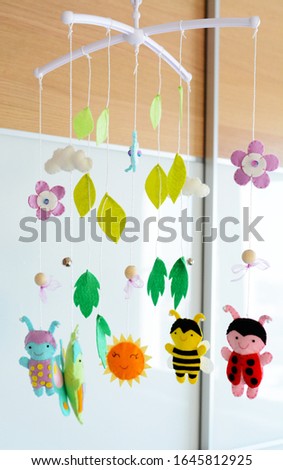 Mobile for crib with different toys in the form of bugs. Handmade toy from felt