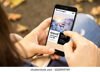 Mobile Design Concept: Woman Holding A 3d Generated Smartphone With Travel Website On The Screen. Graphics On Screen Are Made Up.