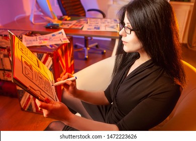 Mobile design development. Front-end developer. Mobile application designer. The girl comes up with the design for the application. The designer thinks about the appearance of the applications.