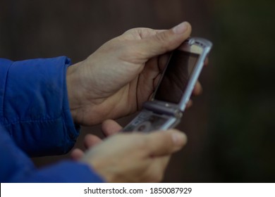 Mobile Folding Cell Phone For Work And Business In The Hands Of A Businessman