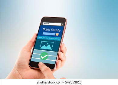 Mobile Friendly Concept.Hands Holding Smart Phone On Blurred Abstract Background