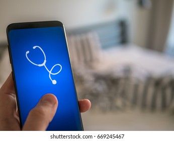 Mobile Health Care App. Person Holding A Phone With Medical Program.