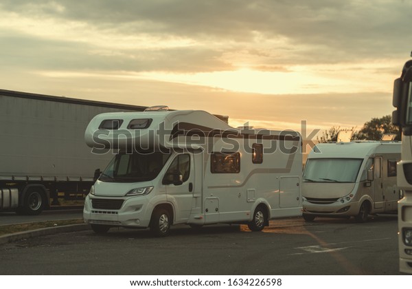 mobile\
home campervan fuels in gas station for an outdoor nomad lifestyle\
camper van caravan vehicle for van life holiday on camper van\
journey camping in the parking near the\
forest.