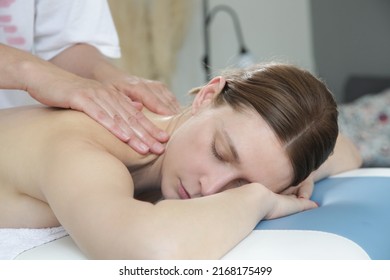 Mobile massage service. Young woman having soft shooting relax massage at home. - Shutterstock ID 2168175499