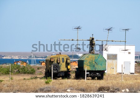 Mobile military radar station on wheels for detecting aerodynamic and ballistic objects. The military facility is located in the steppe on the seashore.