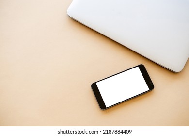 Mobile Mockup. Business Work. Online Technology. Closed Laptop And Smartphone With White Blank Screen On Beige Table Flat Lay.