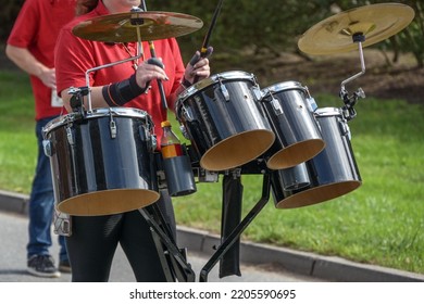 Mobile Musical Instrument, Percussion With Drums And Cymbals Played By A Woman In A Marching Band, Selected Focus, Narrow Depth Of Field