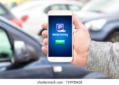 Mobile Parking App On Smartphone Screen Facing Camera. Man Holding Smart Phone With Car Park Application In Hand. Internet Payment Online With Modern Device.