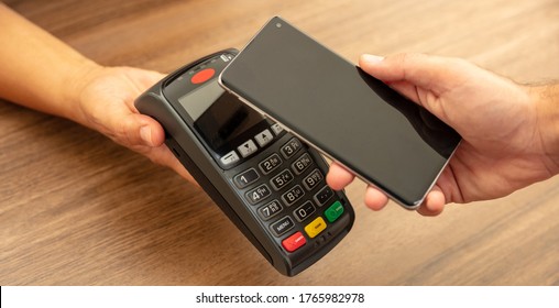 Mobile Payment, Smart Phone Nfc, Near Field Communication Wireless Technology. Cashier And Customer Hands With POS Machine And Smartphone, Closeup View