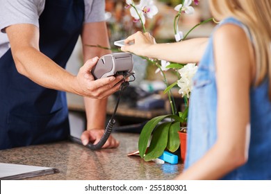 Mobile Payment With Smartphone At Checkout In Nursery Retail Store