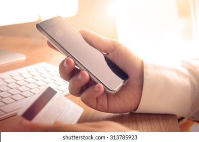 Mobile payments. Male hands using smartphone and credit card for online shopping, m-banking.