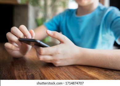 Mobile Phone Addiction Or Cyber Bullying Young Boy On Cellphone