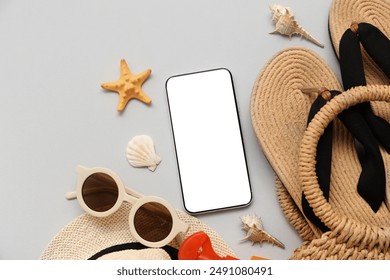 Mobile phone and beach accessories with flip-flops on grey background. Top view - Powered by Shutterstock