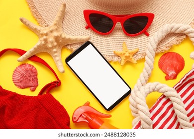 Mobile phone and beach accessories with sunglasses and starfish on yellow background. Closeup - Powered by Shutterstock