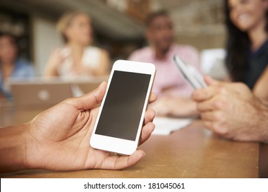 Mobile Phone Being Used By Architect In Meeting