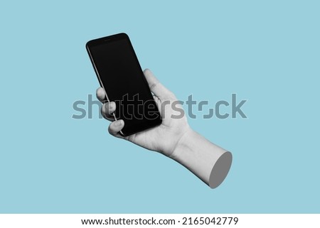 Mobile phone with black screen in female hand isolated on a blue color background. Blank with an empty copy space for the text. Trendy collage in magazine urban style. Contemporary art. Modern design