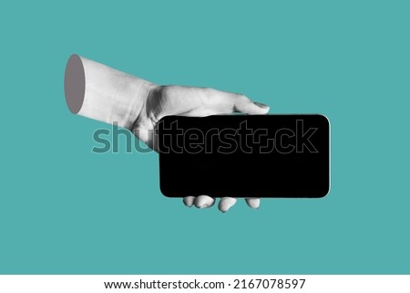 Mobile phone with black screen in female hand isolated on teal blue color background. Blank with empty copy space for the text. Trendy collage in magazine urban style. Contemporary art. Modern design
