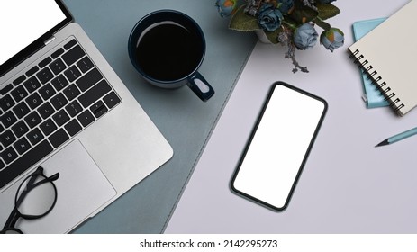 Mobile Phone With Blank Screen, Laptop Computer, Coffee Cup And Notebook On White Table. Flay Lay.