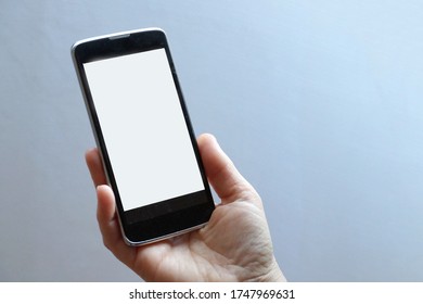 mobile phone with a blank white screen in hand, mock up, copy space