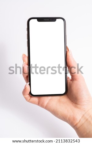 Mobile phone with blank white screen held in one hand on white background