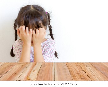 Mobile phone , blur image of Asian girl crying as background.