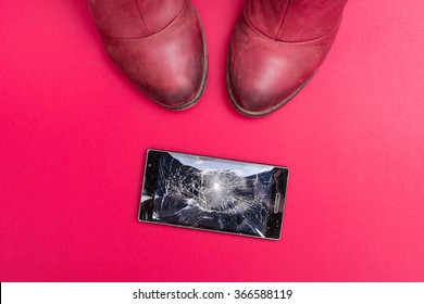 Mobile Phone With Broken Screen On Pink Floor