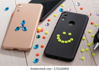 Mobile Phone Cases Being Decorated With Beads And Rhinestones. Beautiful Kids Art, Custom Design And DIY Project Idea.