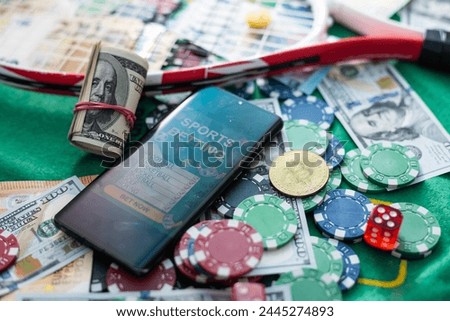 Mobile phone casino online. Mobile phone and game cards with chips and dice on a green gaming table. Gambling addiction in cracking games. Poker online.