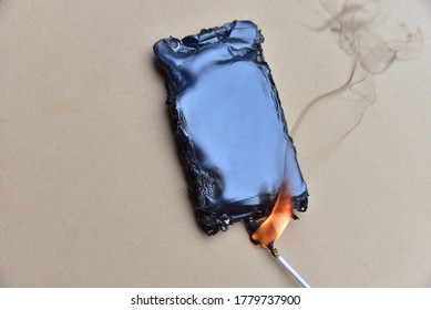 Mobile phone caught fire from the wire with recharging from the electrical network in the socket. Inexpensive chargers put your  cell at risk. Cable overheat and catch fire. Smartphone burn