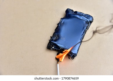 Mobile phone caught fire from the wire with recharging from the electrical network in the socket. Inexpensive chargers put your  cell at risk. Cable overheat and catch fire. Soft focus