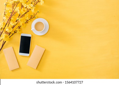 Mobile Phone With Chinese New Year Decoration On A Yellow Gold Background