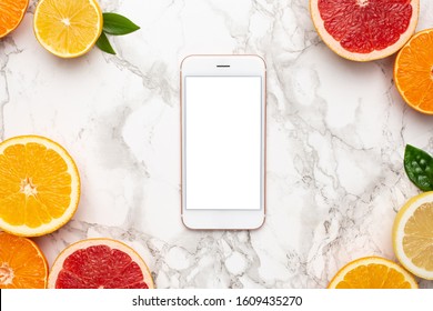 Mobile Phone And Citruses On Marble Background, Fruit Flatlay, Summer Minimal Compositon With Grapefruit, Lemon, Mandarin And Orange Op View