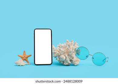 Mobile phone with coral, starfish and sunglasses on blue background - Powered by Shutterstock