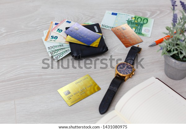 mobile phone and credit card,\
key and wallet on brown wood table, accessories of\
businessman.