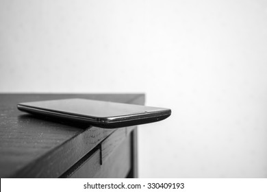 Mobile Phone Is Dangerous Lies On The Edge Of The Table, Carelessly Left With The Probability Of Fall